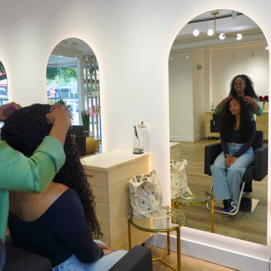 Client enjoying curly hair styling at Destini Curl Spa