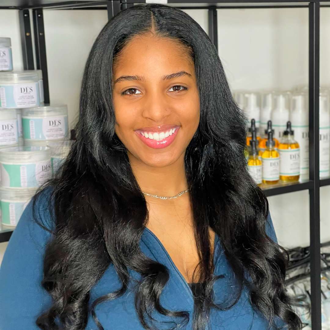 Beaded weft style on curly hair with luxury volume and length extensions.