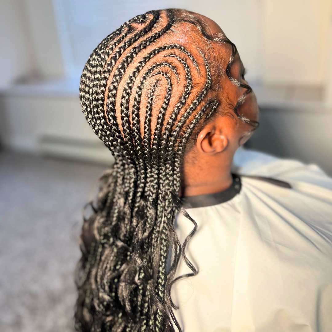 Close-up of feed-in braids hairstyle with neat, tight braiding on natural curly hair