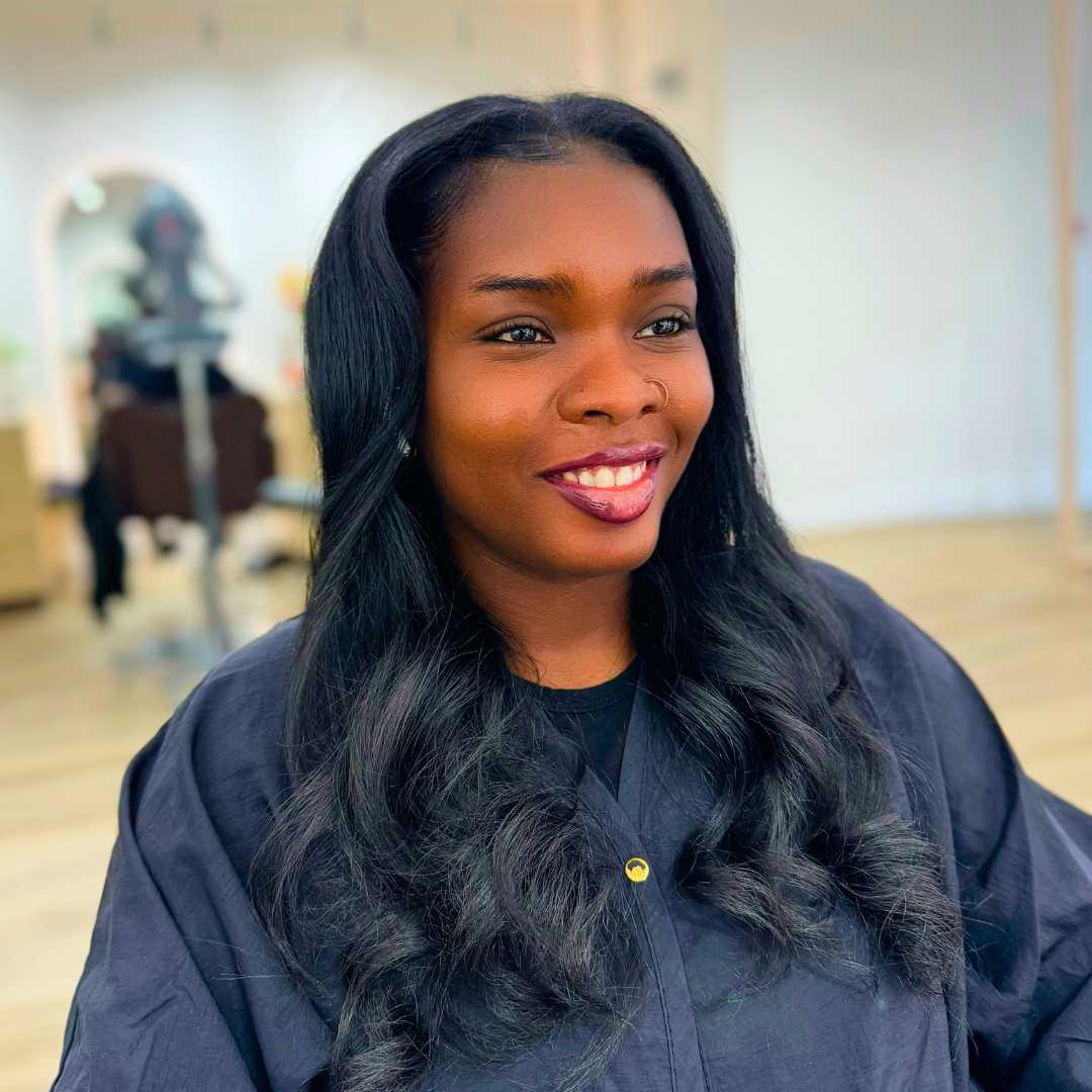 Silk press with bouncy curls offering sleek texture and defined curl pattern